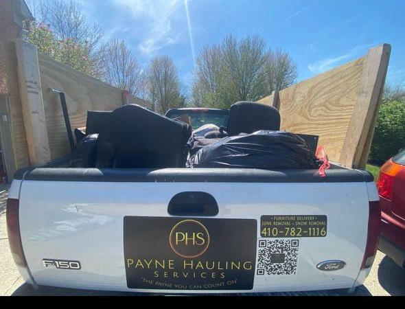 Doug Payne's Ford F-150 loaded with junk, with a Payne Hauling Services magnet on the tailgate